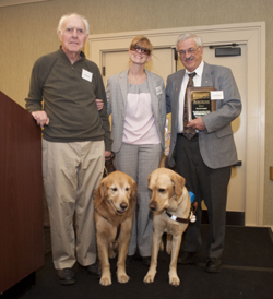 Dave Couture, Ken Bowles, Volunteer Coordinator Jen Buchanan along with Ken and Jen's guide dogs at the awards presentation