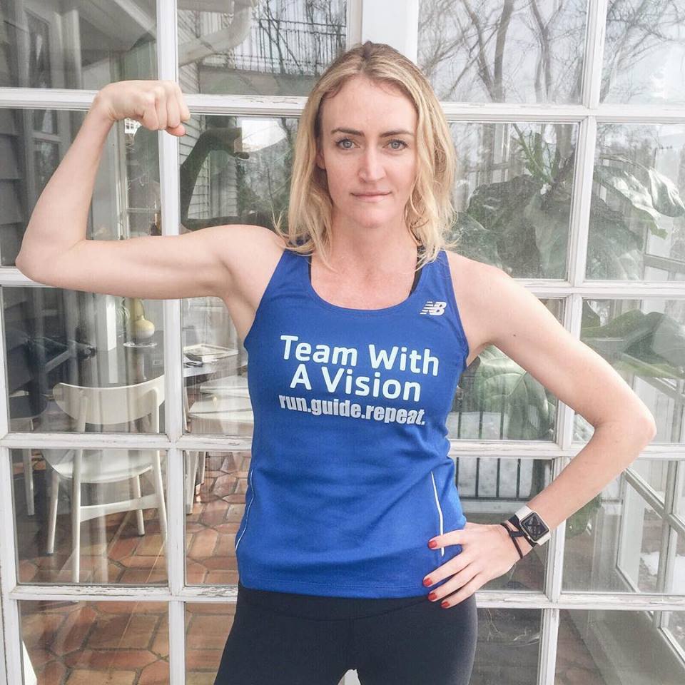 Heather B. Armstrong posing in a Team With A Vision shirt while flexing her bicep