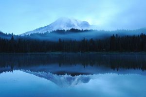 A mountain with a lake below reflecting it