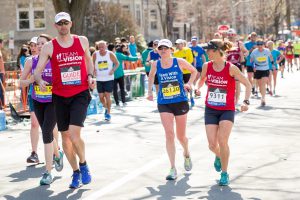 Team Cron, three runners in Team With A Vision shirts running the Boston Marathon