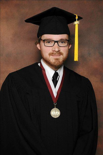 John Griffin in cap and gown at his UMass Amherst graduation