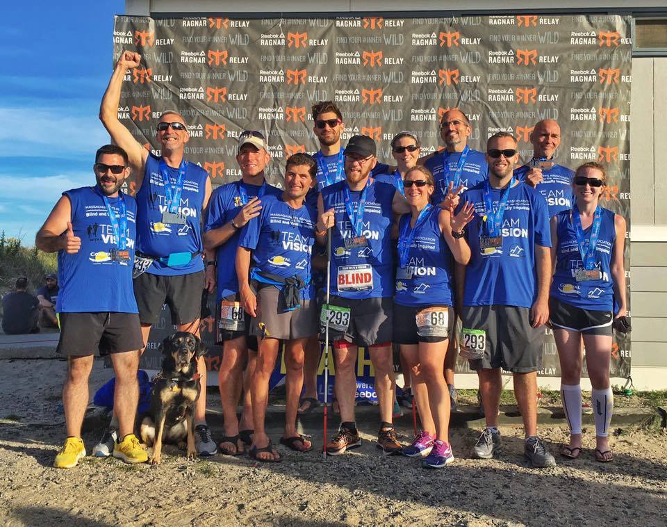 Team With A Vision and Team Coastal Athletic Association pose together with their medals after crossing the finish line