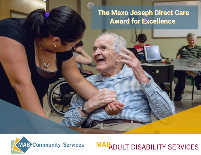Maxo-Joseph-Award-of-Excellence. Image of a direct care worker assiting a participant in a wheelchair