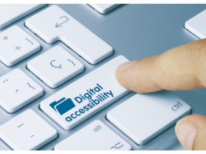 Close up image of a computer keyboard with a finger pushing on a button that says Digital Accessibility