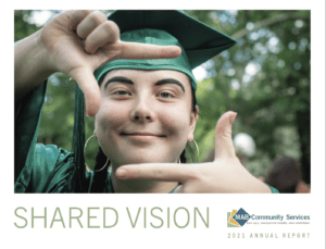 Cover of annual report. Image of a student in cap and gown framing her face with her hands