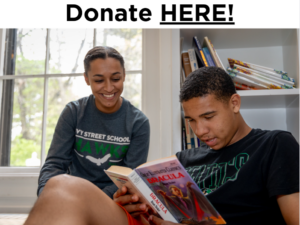 Ivy Street student reading a book with a staff member at the school in Brookline. Text reads Donate HERE.